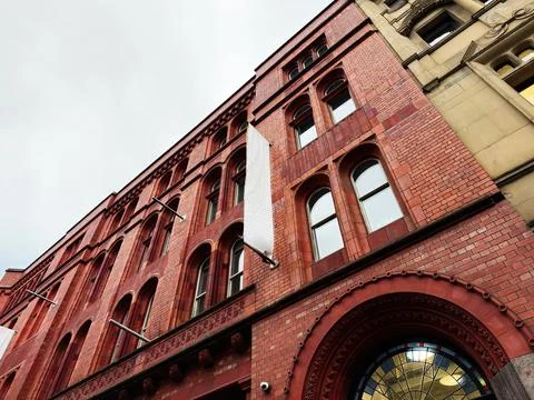Red brick building with arched windows in Manchester, UK, vintage architect.. Stock Photos
