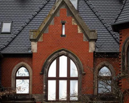 Red brick building facade with arched windows Stock Photos