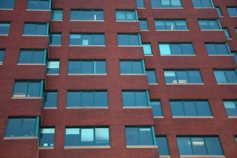 Red brick building facade windows wall urban modern real estate Stock Photos