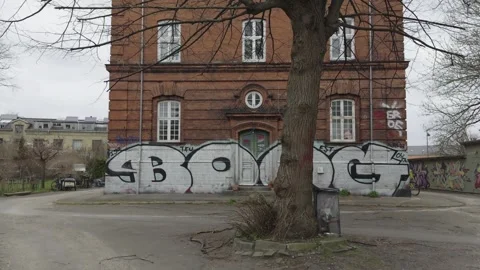 Red brick building features street art in Freetown Christiania Stock Footage 334917862