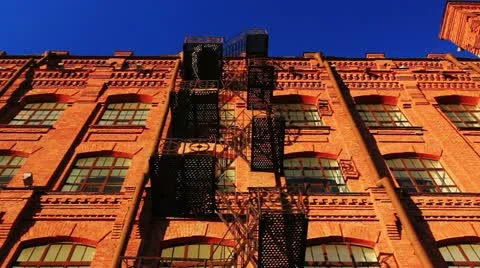 Red brick building, with a fire staircase Stock Footage 22330734