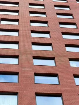 Red brick building with geometric window pattern Stock Photos