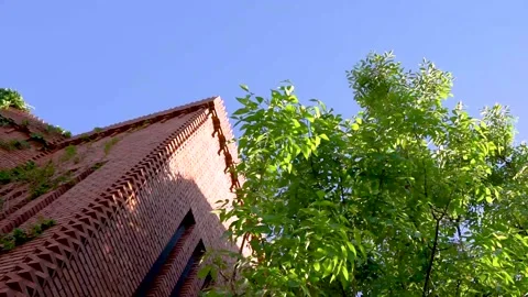 Red brick building leaves sky garden Stock Footage 154750768