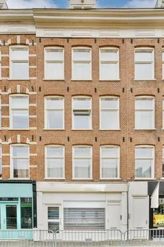 A red brick building with white windows Stock Photos