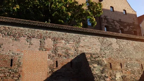 Red brick building with windows on the side.   Torun is city on Vistula Riv.. Stock Footage 236030296