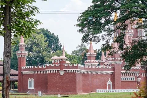 Red brick castle with pointed turrets and white trim Stock Photos