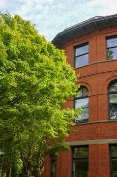 Red brick corner building with rounded facade Stock Photos