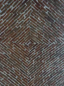 Red brick domed attic. Background of narrow bricks arranged in a herringbone Stock Photos