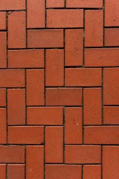 Red brick driveway in herringbone pattern, tumbled brick patio texture Stock Photos
