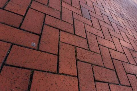 Red brick driveway in herringbone pattern, tumbled brick patio texture Stock Photos