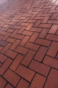Red brick driveway in herringbone pattern, tumbled brick patio texture Stock Photos