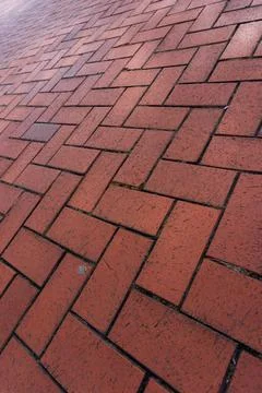 Red brick driveway in herringbone pattern, tumbled brick patio texture Stock Photos