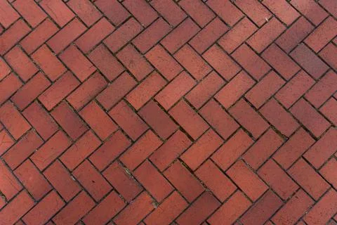 Red brick driveway in herringbone pattern, tumbled brick patio texture Stock Photos