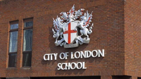 The red brick facade and official crest of the City of London School Stock Footage 327643893