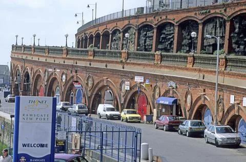 Red brick facade with consecutive arches Stock Photos