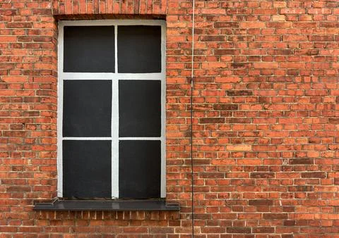 Red Brick Facade with Covered Window for Renovation Work 库存照片