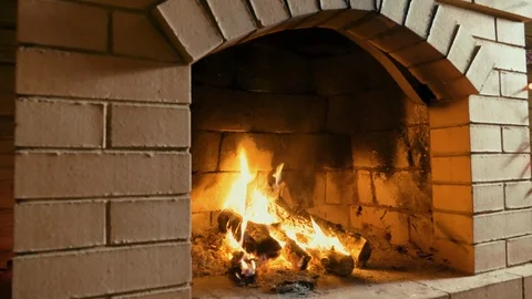 Red brick fireplace with burning fire Stock Footage 115894602