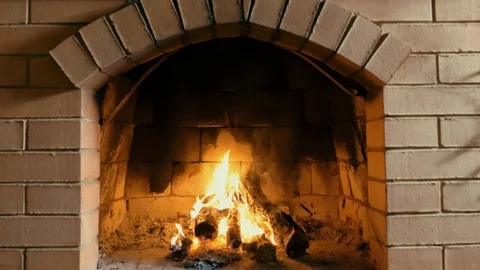 Red brick fireplace with burning fire Stock Footage 115897904