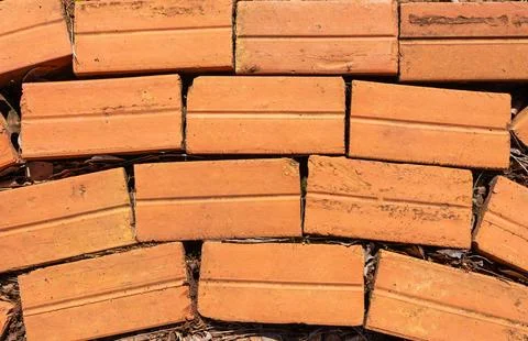 Red brick floor pattern arranged in horizontal rows with natural gaps and soi Stock Photos