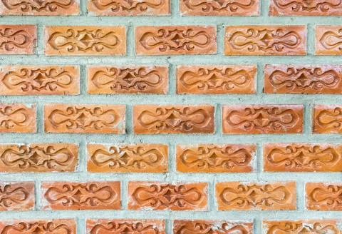 Red brick with the flower pattern on the concrete wall. Stock Photos