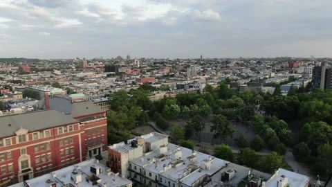 Red brick institutional building among Bushwick rooftops 库存影片 154617905