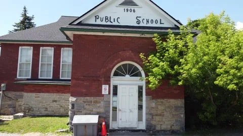 Red brick old school 1906 aerial 4K zoom out Stock Footage 201436014