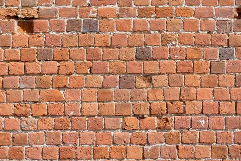 Red brick pattern. An old brick wall with cracks and scratches. A wall with the Stock Photos