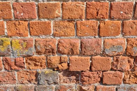 Red brick pattern. An old brick wall with cracks and scratches. A wall with the Stock Photos