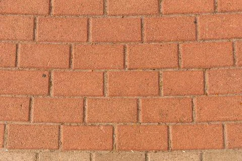 Red brick pavement texture with a regular, rectangular pattern. Stock Photos