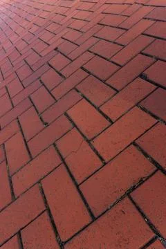 Red brick paver texture background, herringbone pattern pavement close up Stock Photos