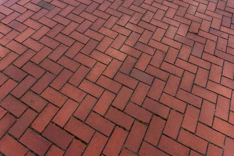 Red brick paver texture background, herringbone pattern pavement close up Stock Photos