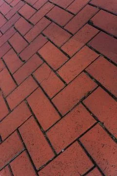 Red brick paver texture background, herringbone pattern pavement close up Stock Photos