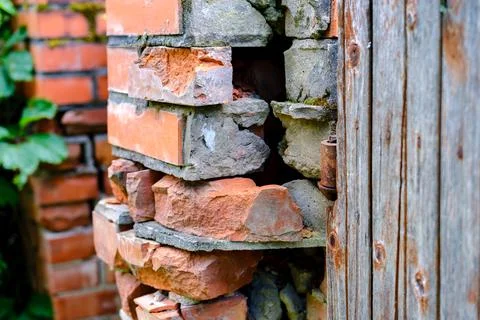 The red brick pillar is collapsing. Stock Photos