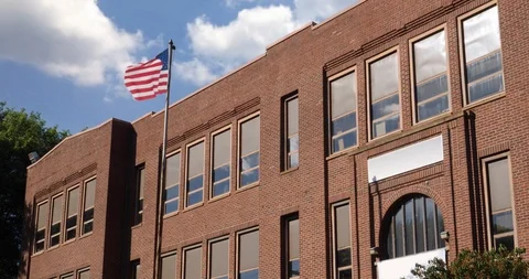 Red Brick School Building with American Flag Stock Footage