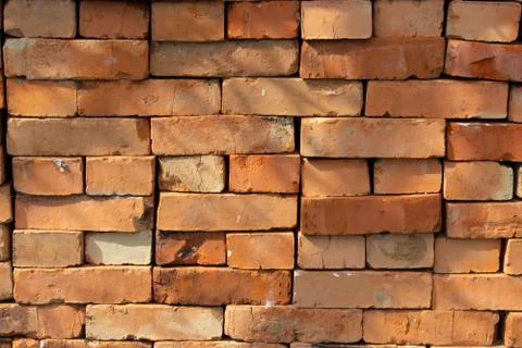Red brick stack, background texture pattern. A pile of bricks material for co Stock Photos