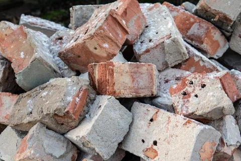 Red brick stack. Old, used building material. Waste recycling and reusable Stock Photos