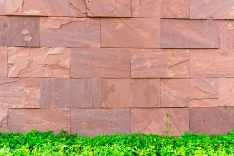 Red brick texture background wallpaper with green grass. Building and interio Photos