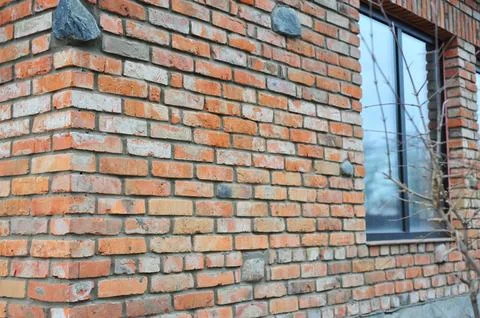 Red brick texture of the corner of the house. Red Brick wall for background o Stock Photos