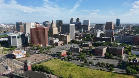 Red brick tower rises above sprawling parking lots near downtown high-rises Stock Footage 340140701