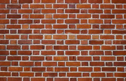Red brick wall. Abstract background of old wall. Stock Photos