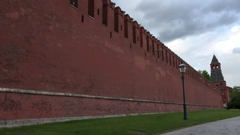 Red brick wall of aged fortification under cloudy sky Stock Footage 144419278