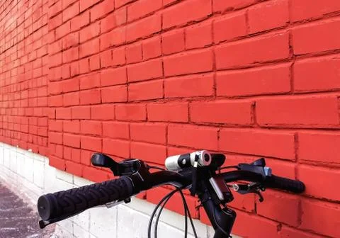 Red brick wall background, texture, the colors of the Polish flag,bike agains Stock Photos
