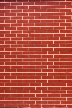 Red brick wall background with white grout lines. Texture of a classic red .. Foto stock