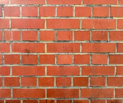 Red brick wall with cement mortar in daylight 写真素材