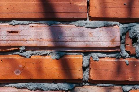 Red brick wall with cement Foto stock
