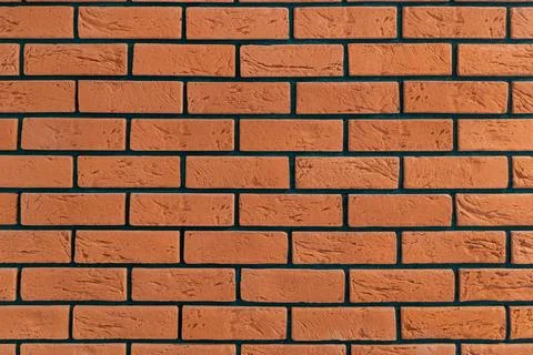 Red brick wall with distinctive black mortar lines Foto stock