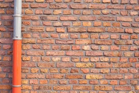 Red brick wall with gutter pipe Stock Photos