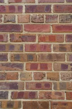 Red brick wall with interesting patterned stains Stock Photos