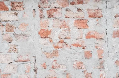 Red brick wall, old surface with peeling plaster. Texture masonry. Vintage ba Stock Photos