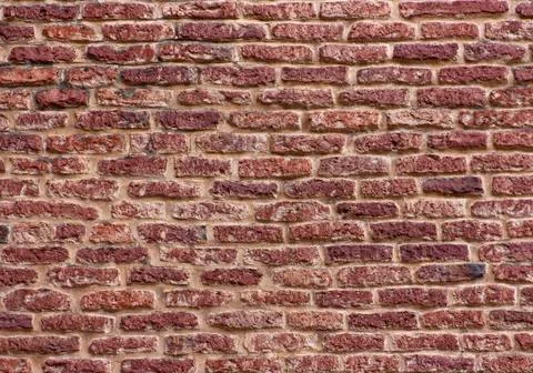 Red brick wall or old dark brown, orange brick fences, blocks of stone Stock Photos